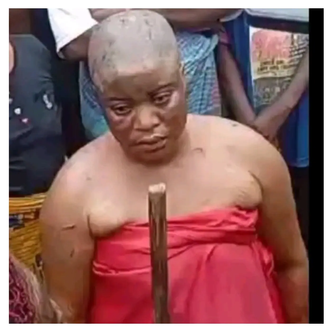 Community parades ex-monarch's wife for allegedly burying charms